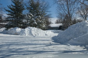 Snow plows make massive piles in front yards.  At least they're plowing . . .